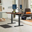 Electric Standing Desk 48x30 Darkwood in raised position at home