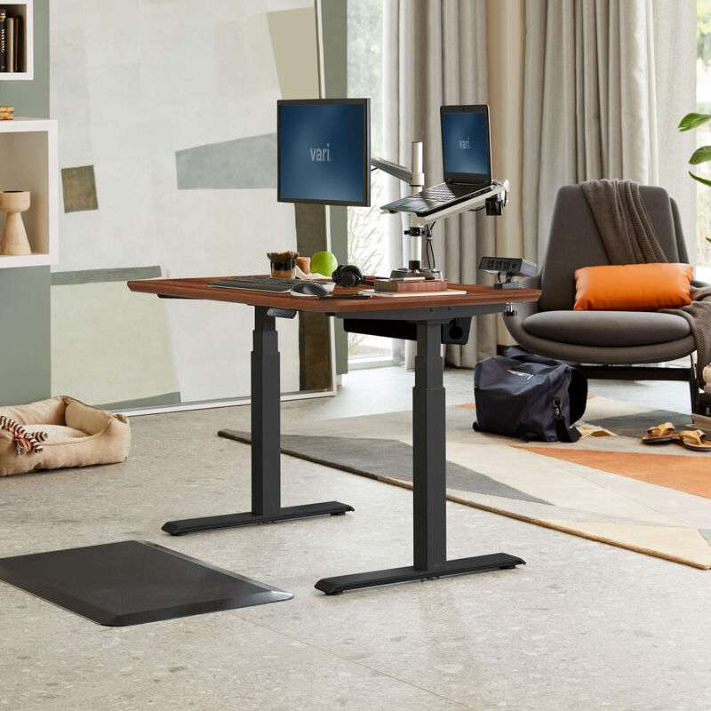 Electric Standing Desk 48x30 Darkwood in raised position at home image number null