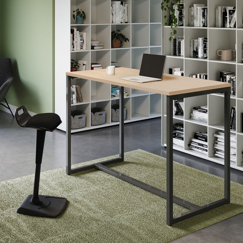 standing work table in light wood finish setup in an open workspace environment with an active seat and laptop in use on top of the table image number null