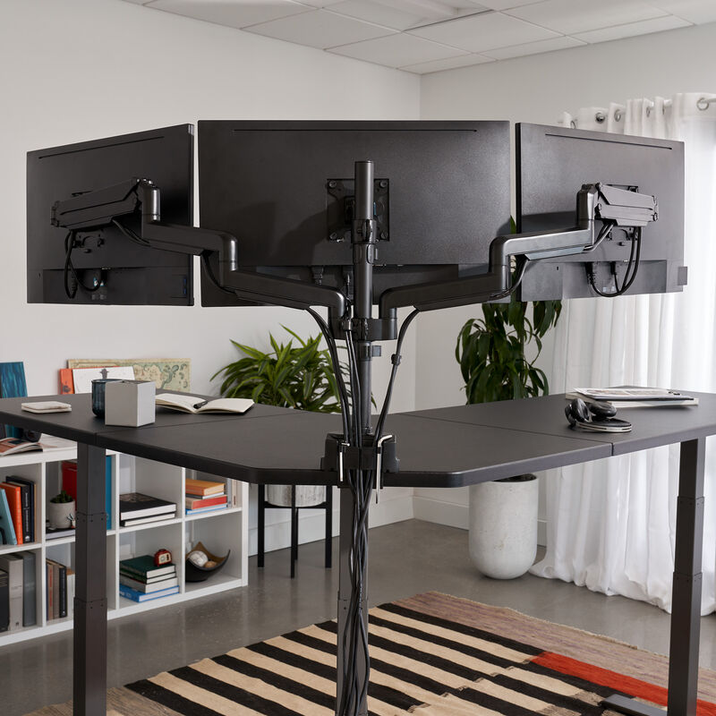 close up of the back of the triple monitor arms with three monitors setup on a vari l shape desk image number null