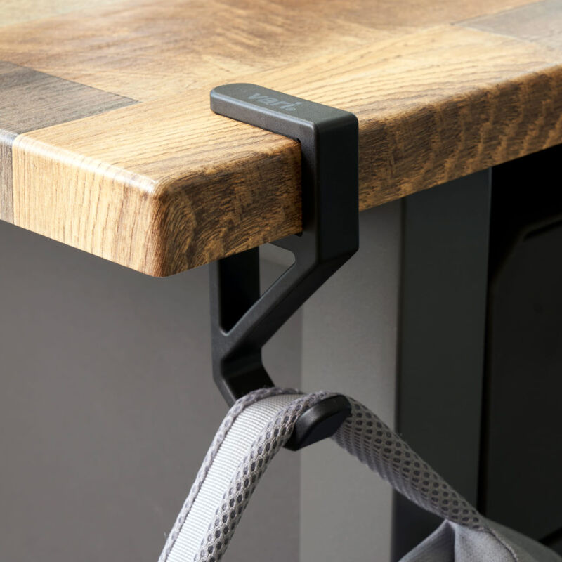 desk hook holding a bag on the edge of an electric standing desk image number null