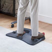 Individual with socks on standing on the ActiveMat in a home office