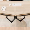 overhead view of the dual monitor arms installed on a desk showing how far back the elbows of the monitor mount sticks out