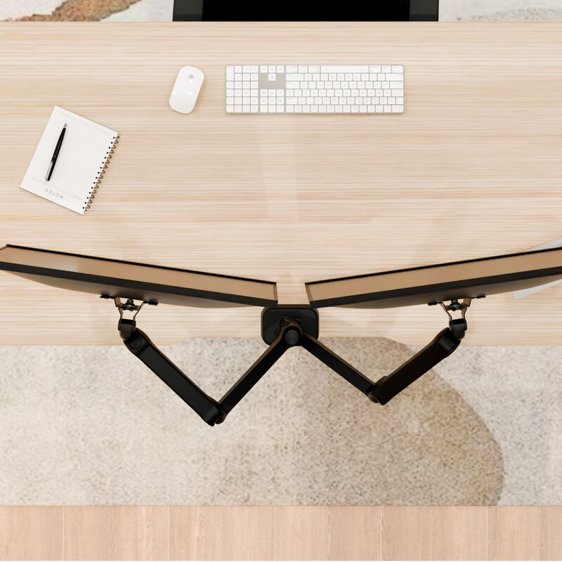 overhead view of the dual monitor arms installed on a desk showing how far back the elbows of the monitor mount sticks out image number null