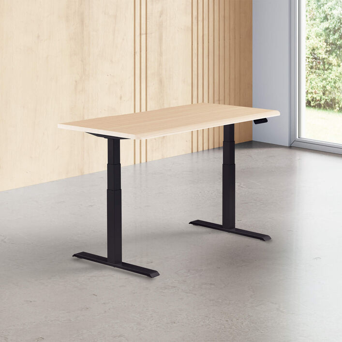 light wood finish standing desk top with black legs in a open office image number 0