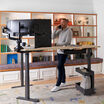 l shape electric standing desk used in a home office setting