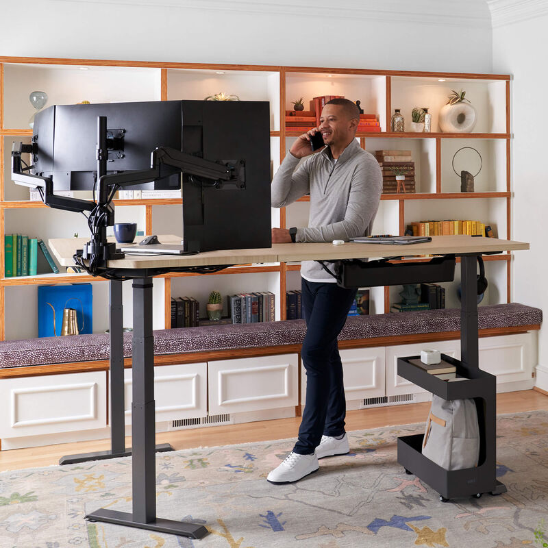 l shape electric standing desk used in a home office setting image number null