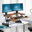 VariDesk Pro Plus 36 Butcher Block sit-stand desk converter in raised position in office image