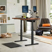 Electric Standing Desk 48x30 Darkwood in raised position at home