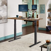Electric Standing Desk 60x30 Reclaimed Wood in raised position at home