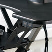 Close-up of the black up and down height adjustment buttons on the side of the desk converter, with the X-frame lift mechanism visible behind.