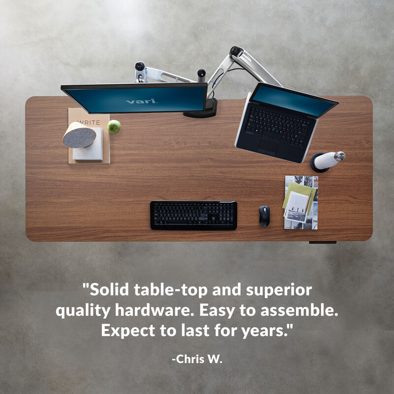 overhead image of an electric standing desk with a quote underneath reading, the assembly was a breeze setup was easy and I actually am joyful to use it everyday image number null