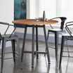 Standing Round Table Butcher Block shown with three chairs in office
