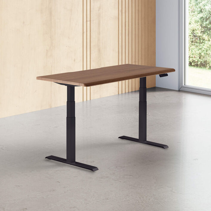 walnut finish standing desk top with black legs in a open office image number 0
