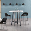 two tall wave side chairs around a tall round table in a cafe area