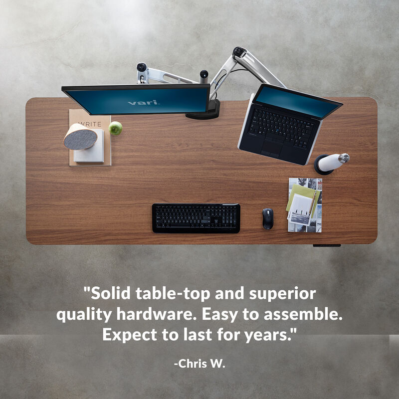 overhead image of an electric standing desk with a quote underneath reading, the assembly was a breeze setup was easy and I actually am joyful to use it everyday image number null