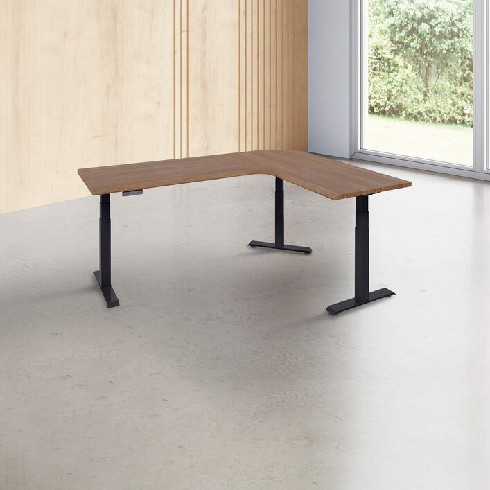 L-shape desk with a walnut finish desk top with black legs in a open office image number 0