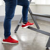 closeup of footrest on reclaimed wood standing work table 60x30 in office setting