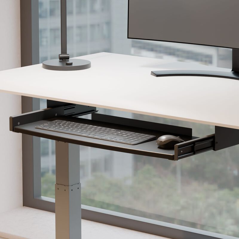 side view of keyboard trey attached to desk with keyboard on white standing desk image number null