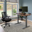 Hybrid work hub with an electric standing desk a dual monitor and laptop stand with task chair and power hub