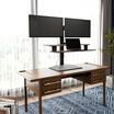 varidesk electric dual monitor converter in walnut in a raised position on desk 