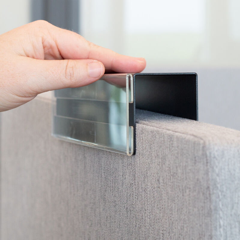 individual putting name plate on cubicle image number null