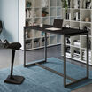 standing work table in black finish setup in an open workspace environment with an active seat and laptop in use on top of the table
