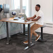 individual sitting on a balance stool while working at a desk