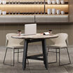 sand grey cafe chairs around round table in lounge setting