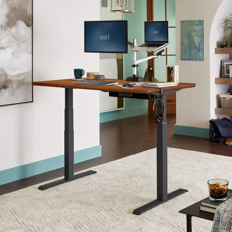 Electric Standing Desk 60x30 Dark Wood in raised position at home image number null