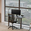 black finish standing desk in an office setting