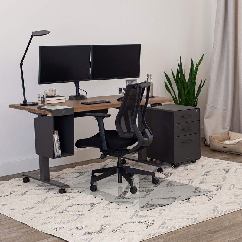 glass chair mat setup under a chair and electric standing desk on a high pile rug image number null