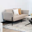 contemporary three-seat sofa in pebble placed in office setting with windows