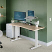 light wood and white standing desk in office in lowered position