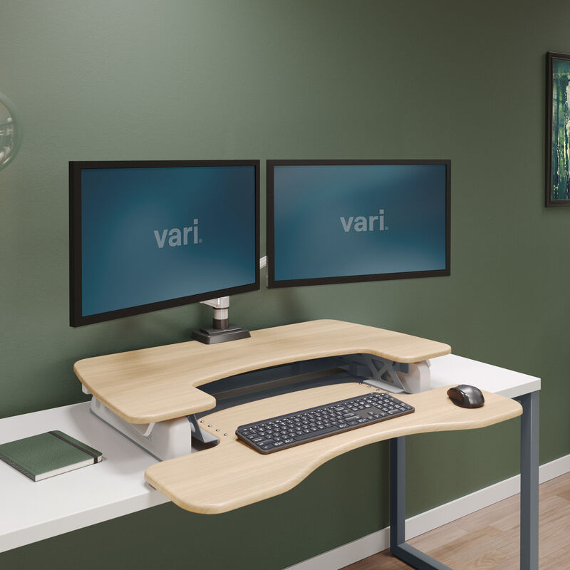 varidesk pro plus 36 light wood sit-stand desk converter in lowered position in home office image number null