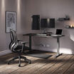 Curve Electric Standing Desk 60x30, Performance Task Chair, Dual-Monitor Arm, Standing Mat 34x20, Power Hub and Power Strip 8ft are all included in this Performance Home office that is set up in a home office setting. 