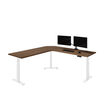 l shape electric standing desk eight by eighty with a walnut desktop and white legs with two monitors sitting on top of it in front of a white background 