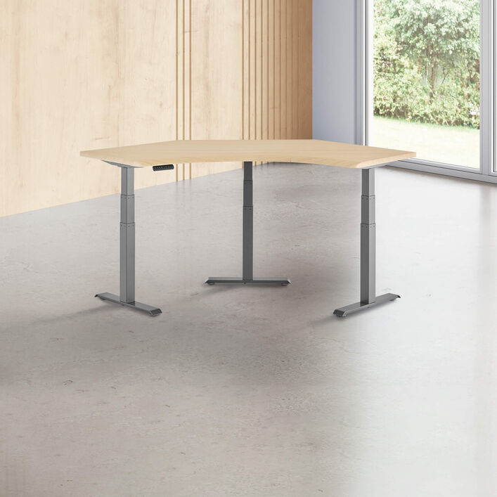 light wood finish standing desk top with slate finish legs in a open office image number 0
