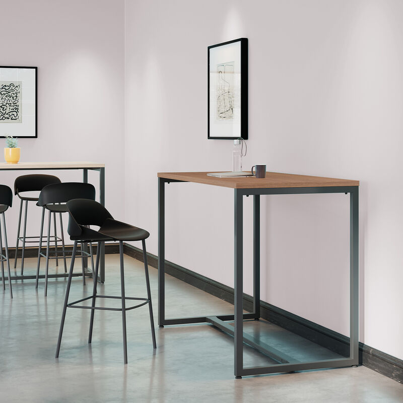 standing work table in walnut finish setup in an open workspace environment with a tall side chair and laptop in use on top of the table image number null