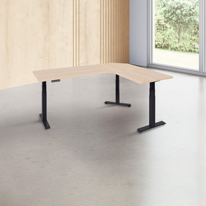 L-shape desk with a light wood finish desk top with black legs in a open office image number 0