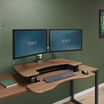 varidesk pro plus 36 walnut sit-stand desk converter in lowered position in home office