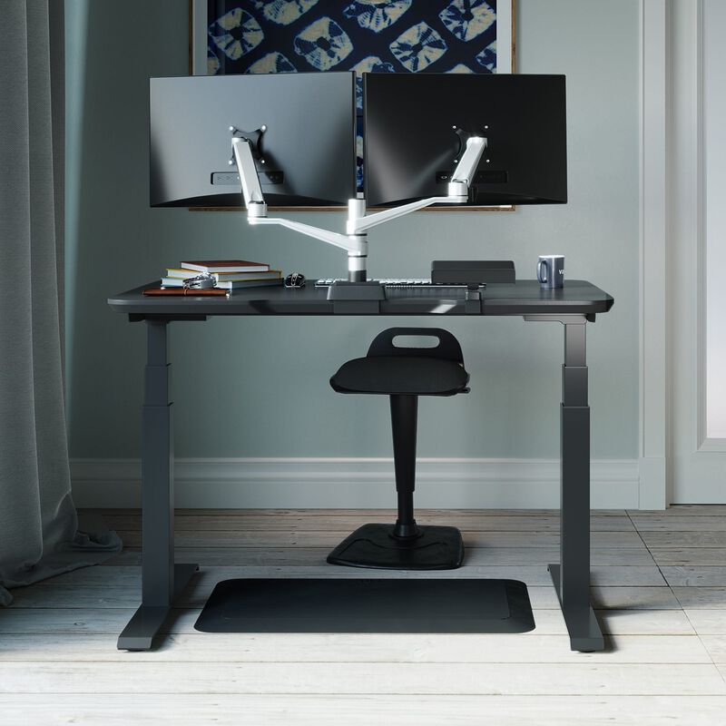 Space-Saving - Complete Sit-Stand Workspace bundle is comprised of the electric standing desk 48 by 30, dual monitor arm, active seat, power hub, and standing mat 34 by 20 image number null
