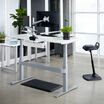 electric standing desk 60x30 discontinued in white with silver legs raised at an office