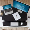 Overhead view of the VariDesk Pro 36 Black sit-stand desk converter lowered on a wooden desk