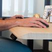 wrist resting comfortably on the slope of desk