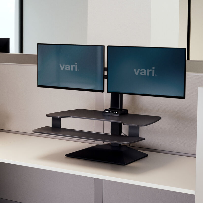 varidesk electric dual monitor converter in black in a raised position on desk  image number null
