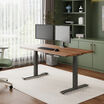 solid wood electric standing desk with a heritage walnut top with slate legs in an open home office in lowered position