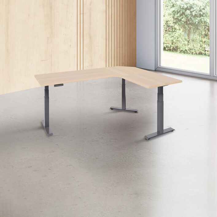 L-shape desk with a light wood finish desk top with slate legs in a open office image number 0