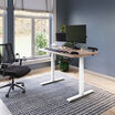 electric standing desk with comfortedge in 48x30 light wood top and white legs in raised position at home