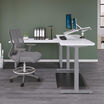 Electric Standing Desk 60 by 24 in raised position in office setting